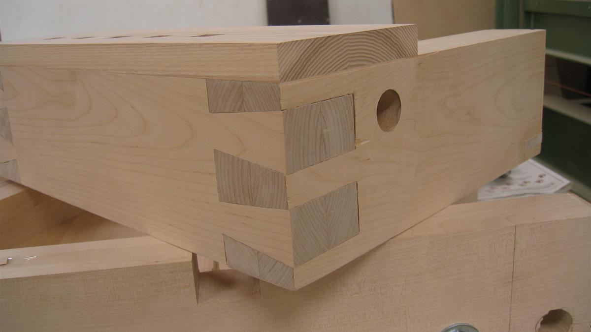 Authentic hand cut drawer dovetail joint on 18th century antique furniture showing narrow pins and hand chiseled scribe lines
